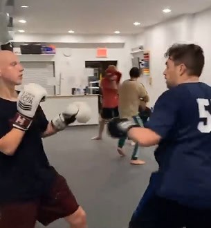 Young men practicing kickboxing at Johnny Karate NYC gym.