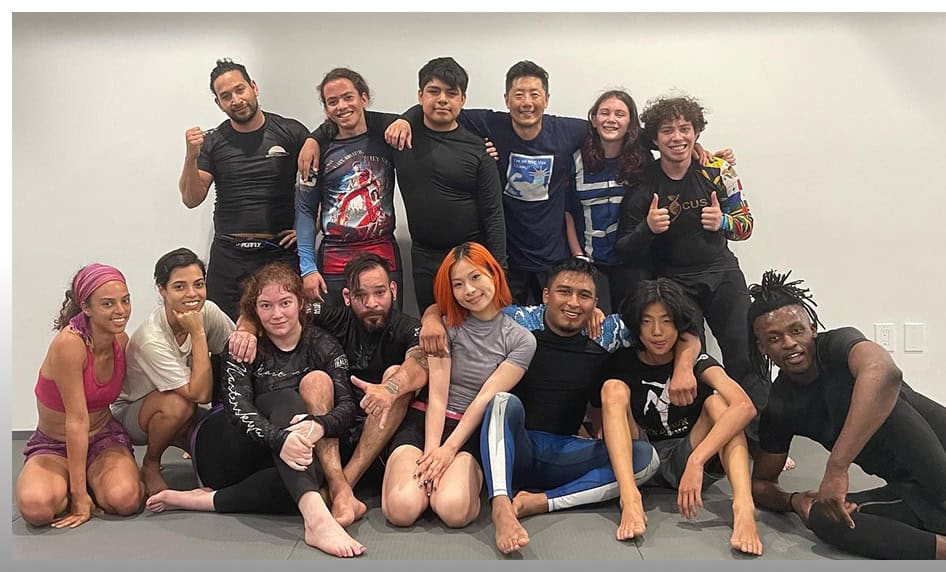 Group of diverse students and instructor after kickboxing training at Johnny Karate NYC.