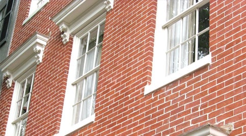 Restoring historic brickwork and tuckpointing on a classic brick building.