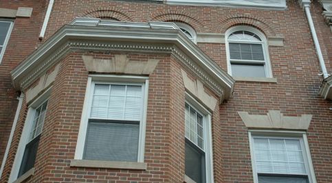 Restoring historic brickwork and tuckpointing on a classic building facade.