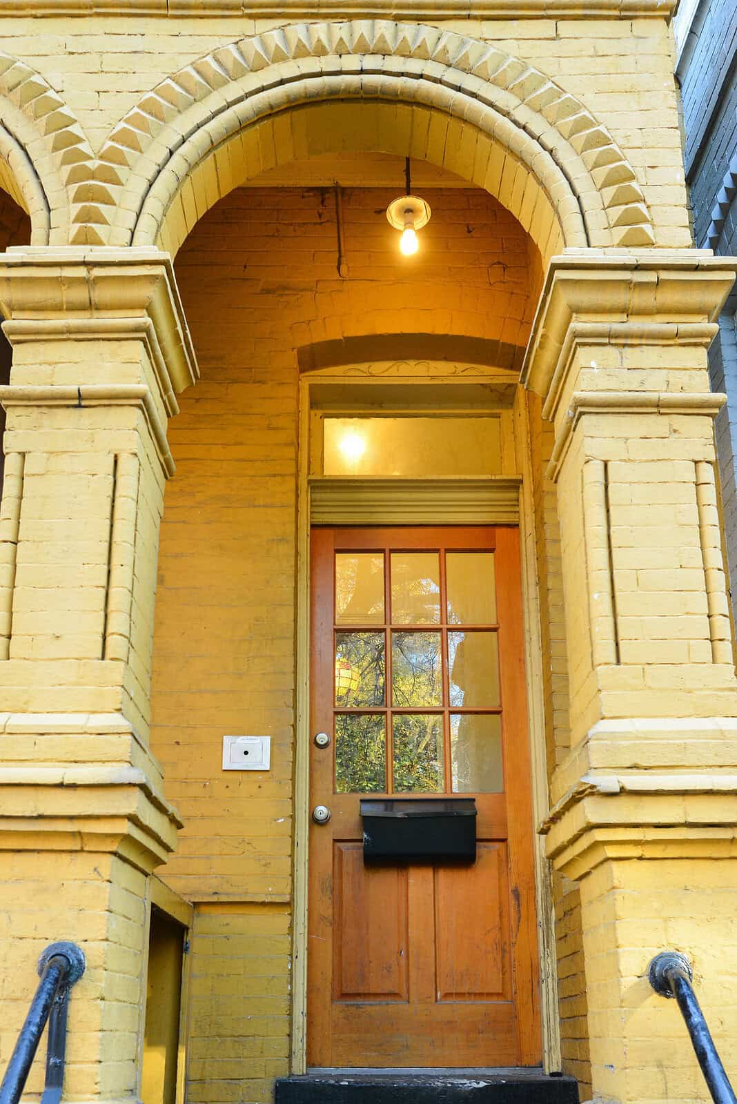 Historic masonry and tuckpointing on a yellow brick building.