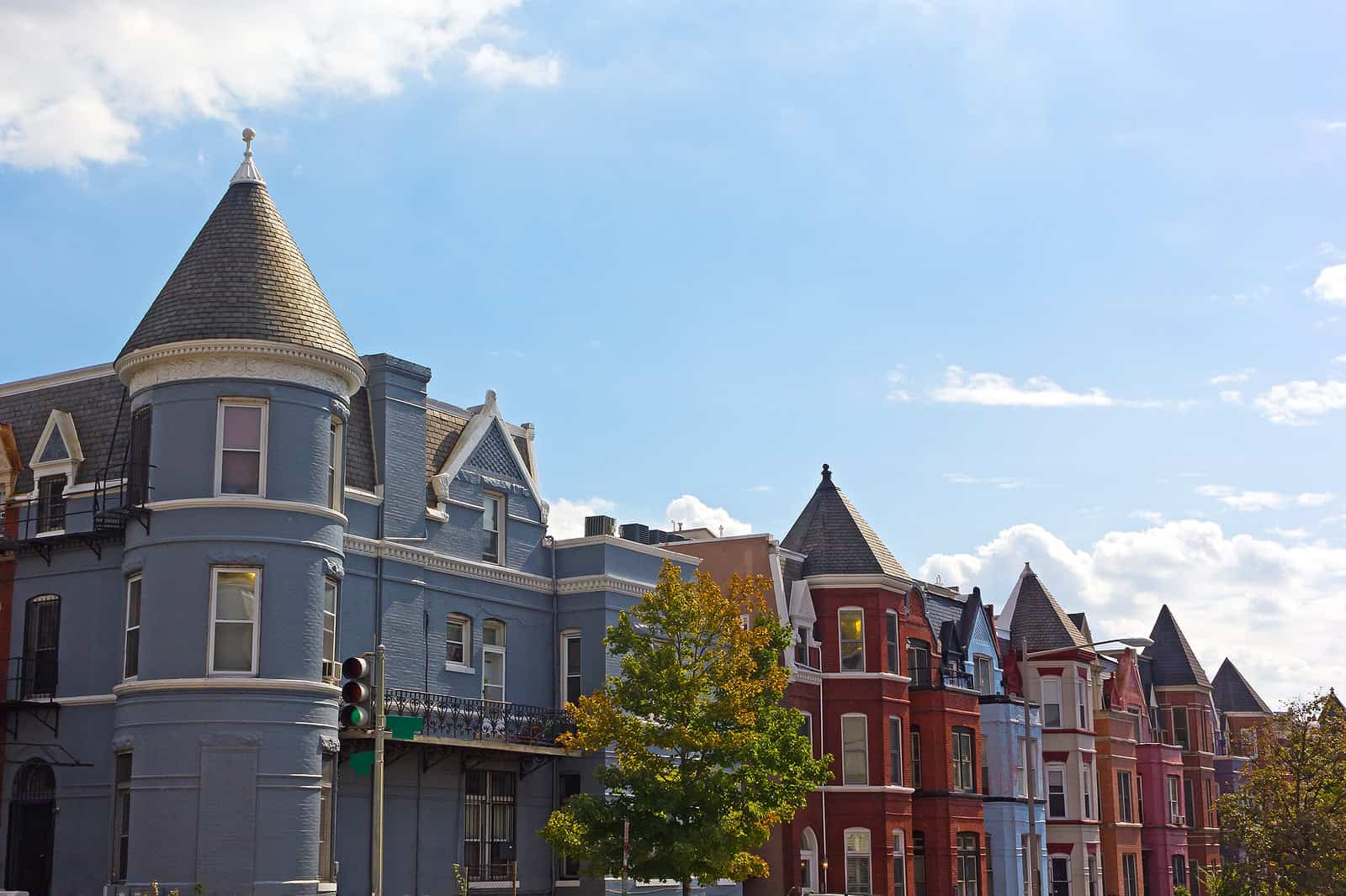 Historic Victorian-style row houses with detailed masonry work and colorful facades.
