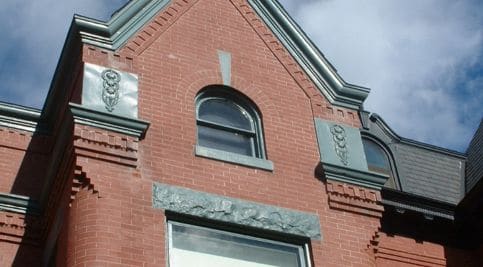 Restoring historic brickwork and tuckpointing on a classic building facade.