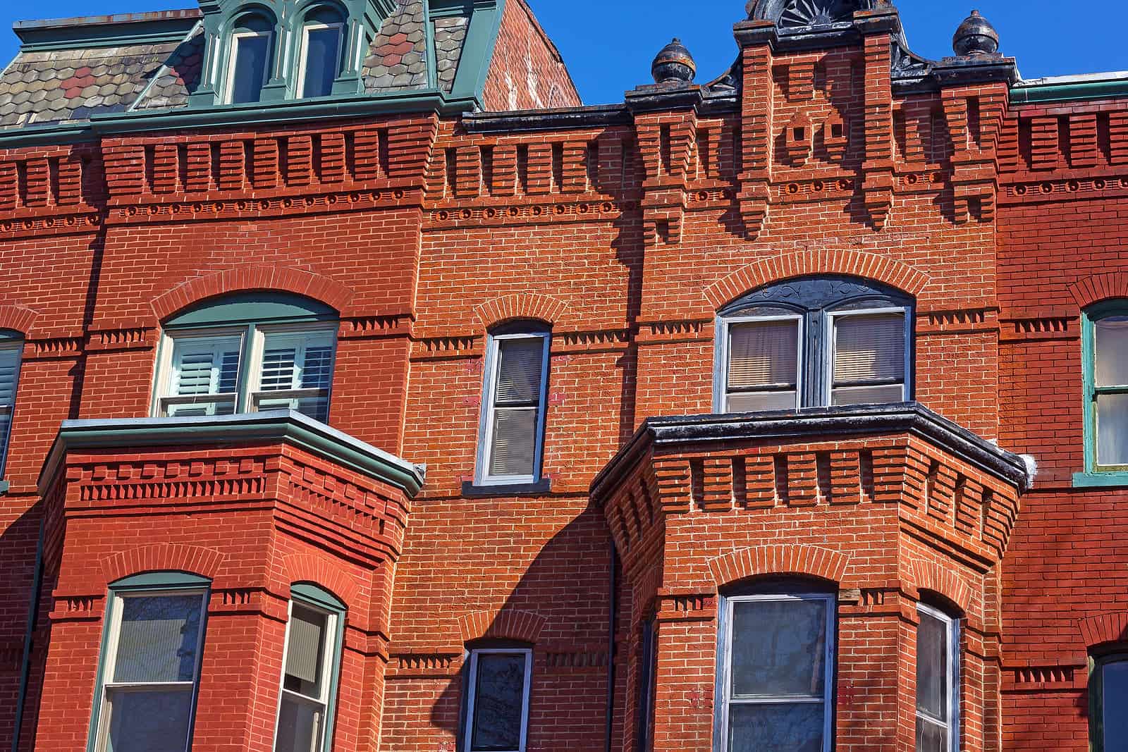 Restoration of historic brick masonry with tuckpointing on a Renaissance-era building.
