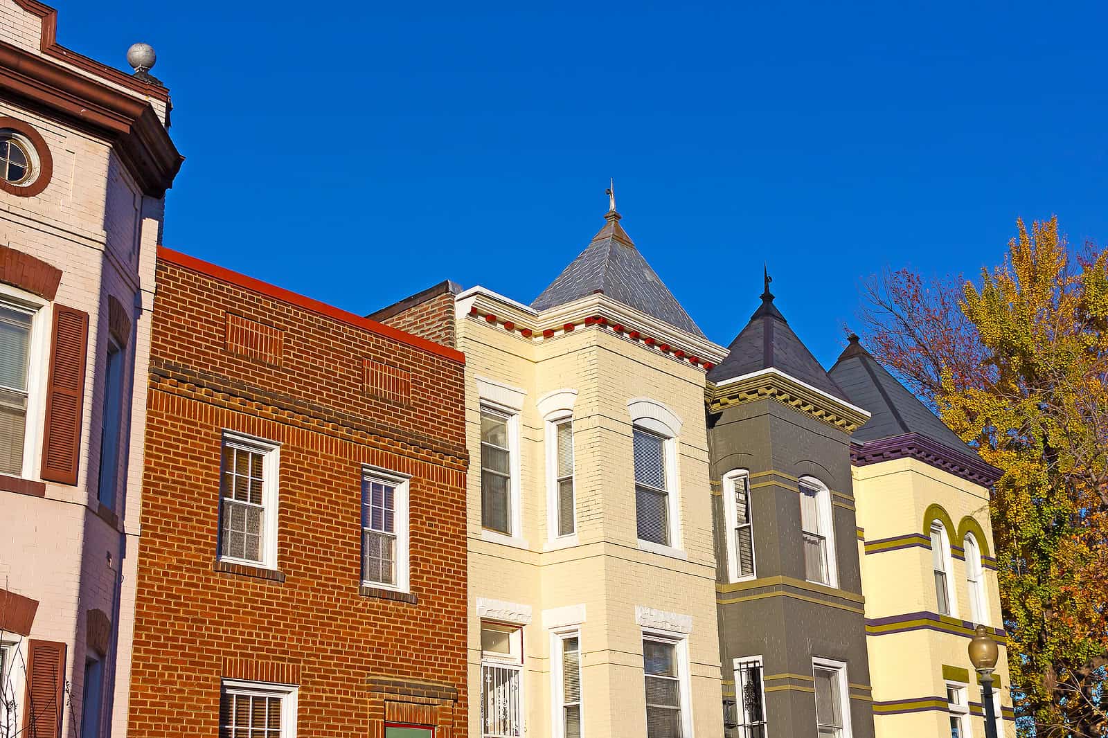 Historic masonry and tuckpointing work on colorful row houses in a historic neighborhood.