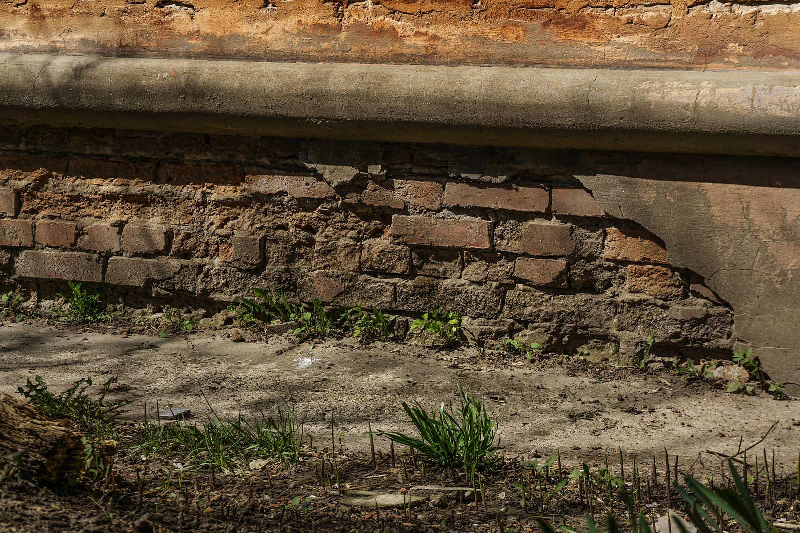 Close-up of historic brick masonry with signs of deterioration and repair work.