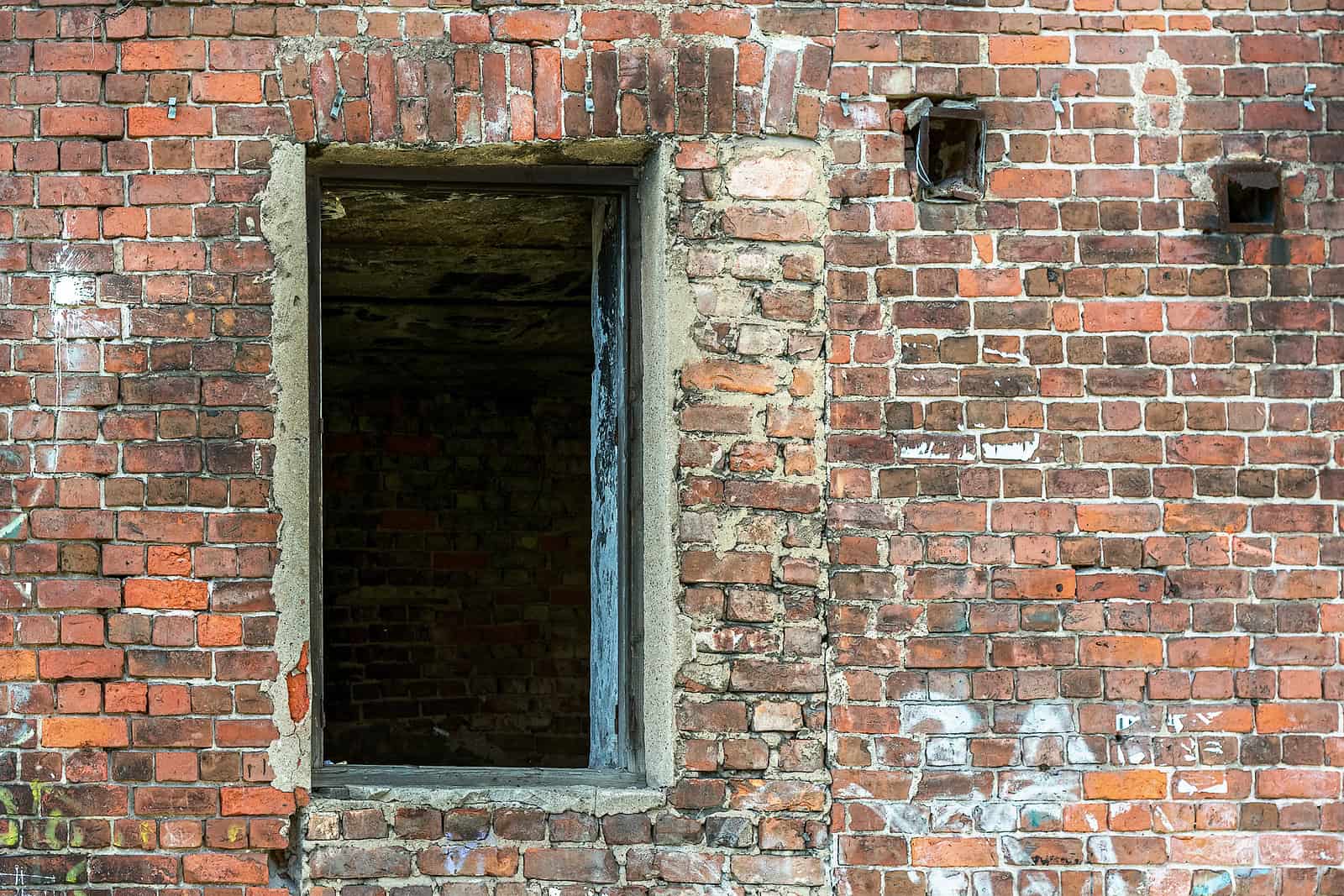 Close-up of historic brick masonry with a window opening in a Renaissance-era building.