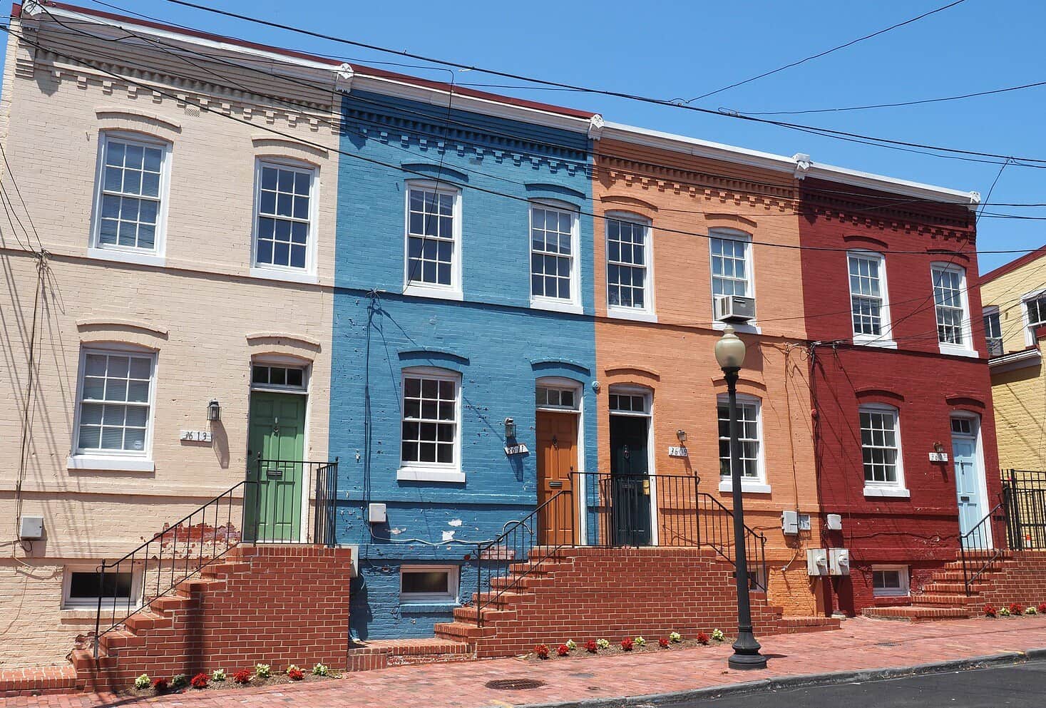 Colorful row houses with detailed brickwork and historic masonry features.