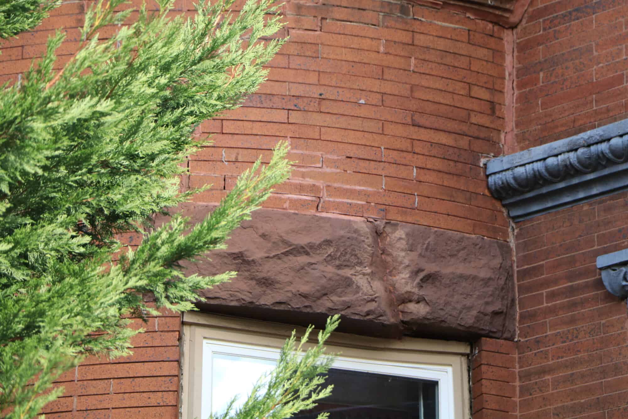 Close-up of historic masonry and tuckpointing on a brick building.