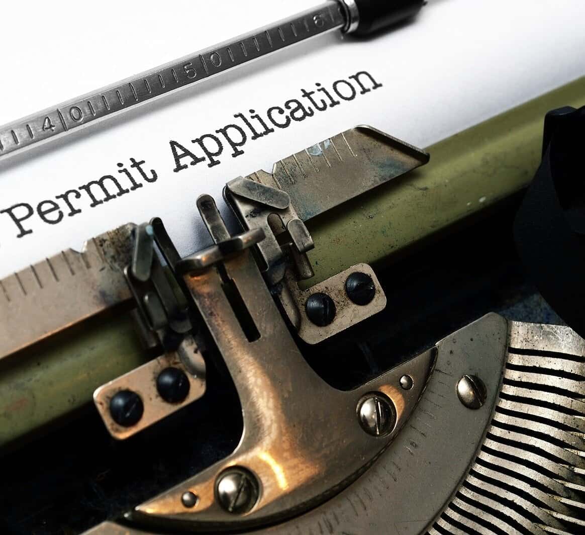 Close-up of a permit application form on a vintage typewriter.