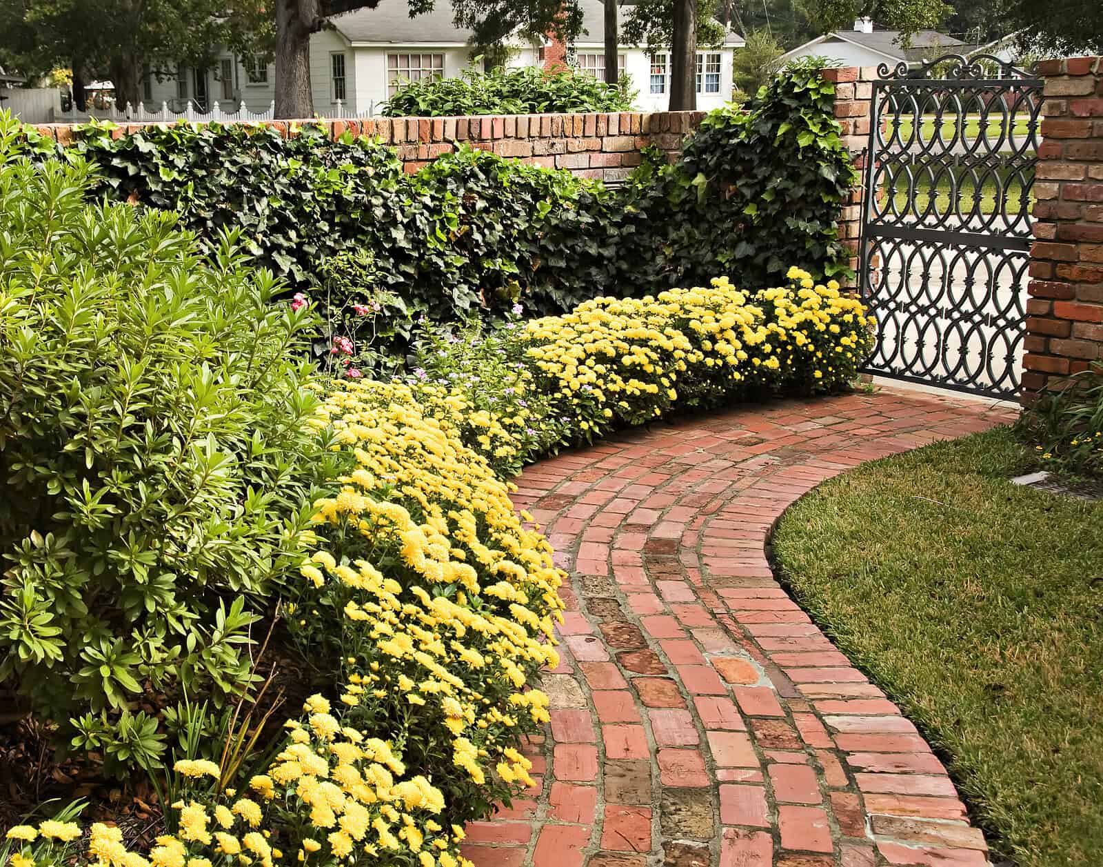 Beautiful brick pathway with historic masonry and lush garden landscaping.