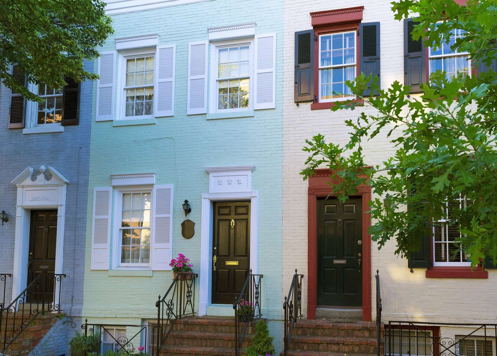 Historic masonry and tuckpointing on colorful row houses in a city neighborhood.