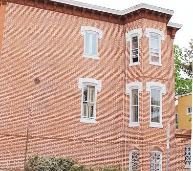 A brick facade of a two-story historic brick building in Washington, DC.