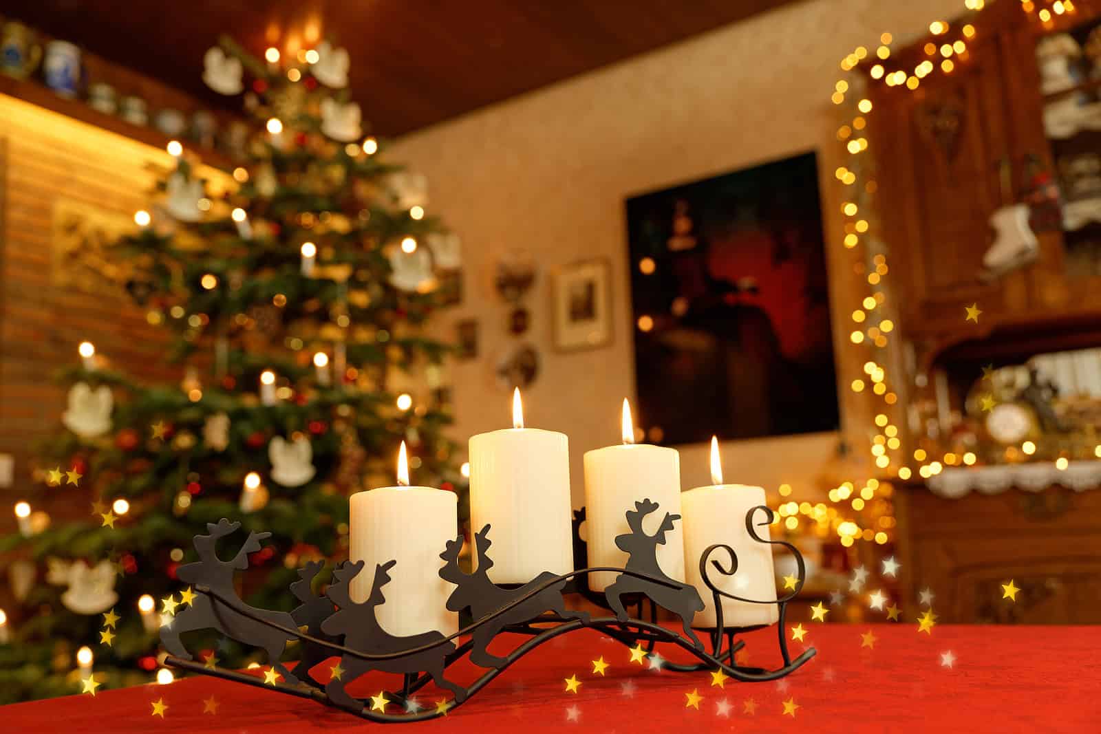 Festive holiday scene with candles and Christmas tree in a cozy home setting.