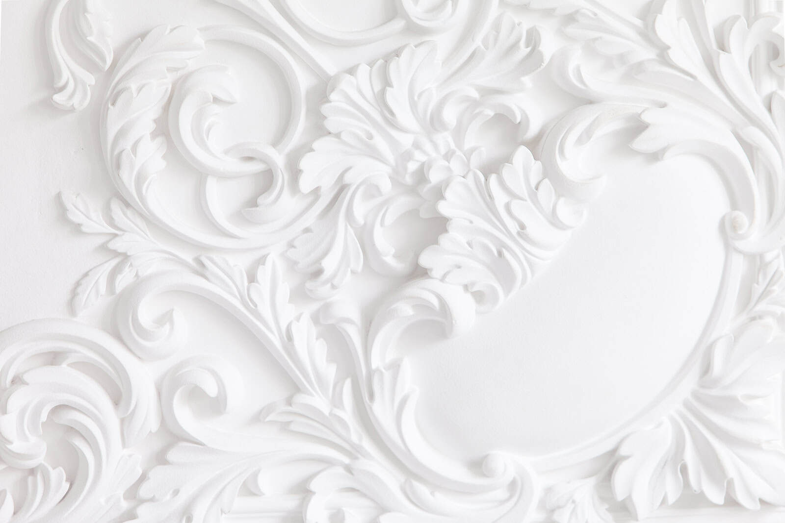 Intricate white masonry with detailed decorative carvings and tuckpointing work.