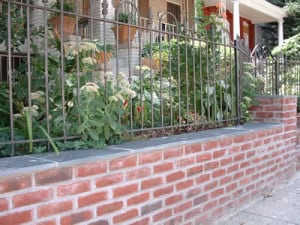 Beautiful brick masonry with detailed tuckpointing on a garden wall.