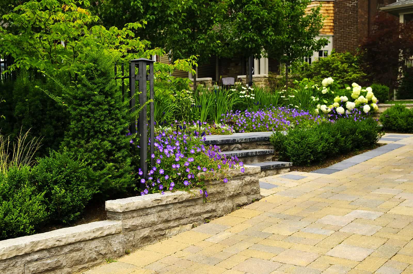 Beautiful landscaped garden with stone steps and vibrant flowers.