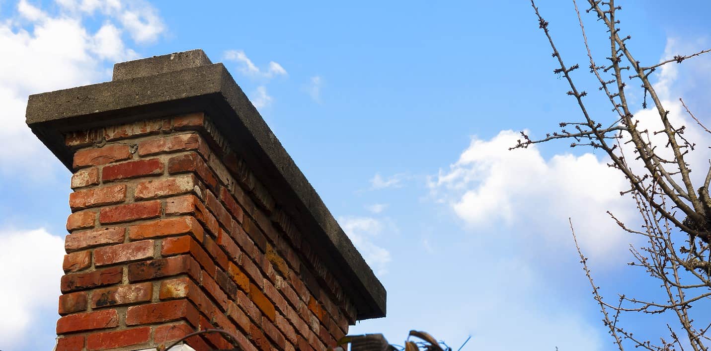 Close-up of historic brick chimney with detailed tuckpointing work.