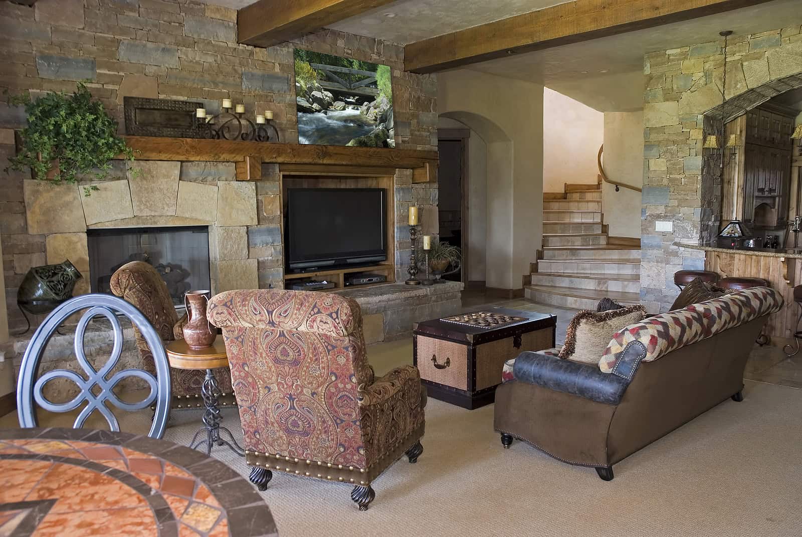 Elegant living room with stone fireplace and cozy seating area.