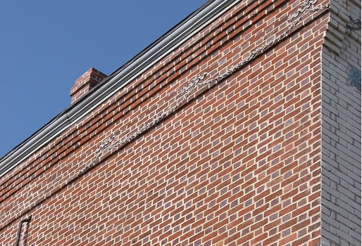 Close-up of historic brick masonry and tuckpointing work on a building.