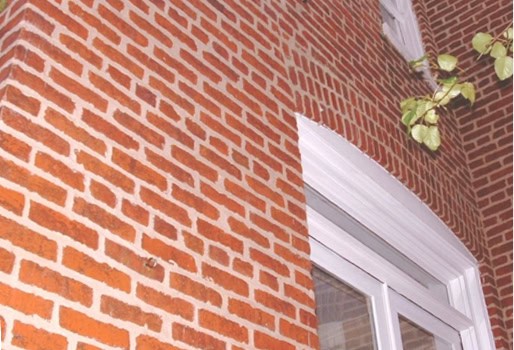 Historic brick masonry and tuckpointing on a building exterior.