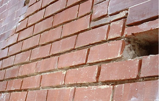 Restoration of historic brick masonry with precise tuckpointing and masonry work.
