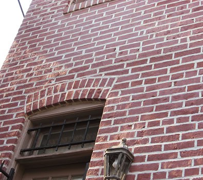Close-up of historic brick masonry and tuckpointing work on a building facade.