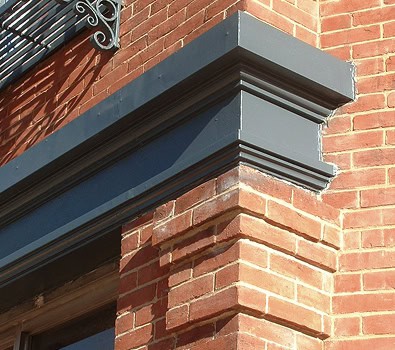 Close-up of historic masonry and tuckpointing on a brick building corner.
