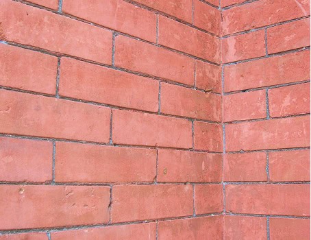 Brick wall with detailed mortar joints and historic masonry finish.