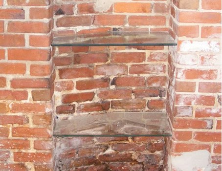 Restored brick masonry with tuckpointing on historic building wall.