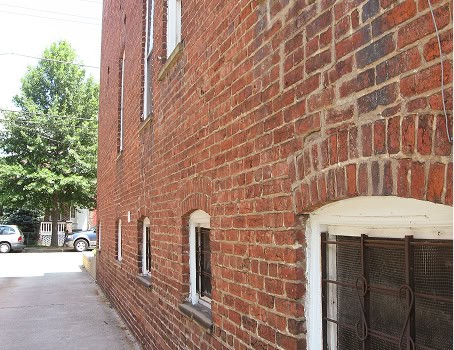 Historic brick masonry and tuckpointing work on a building exterior.