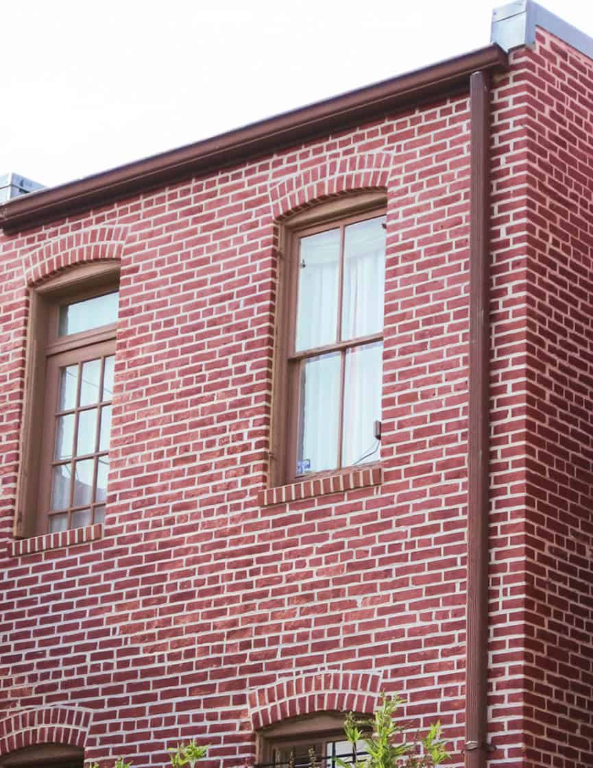 Historic brick masonry and tuckpointing on a Renaissance-style building facade.