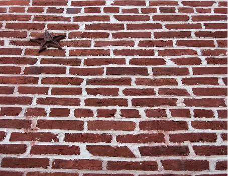 Close-up of a historic brick masonry wall with tuckpointing details.