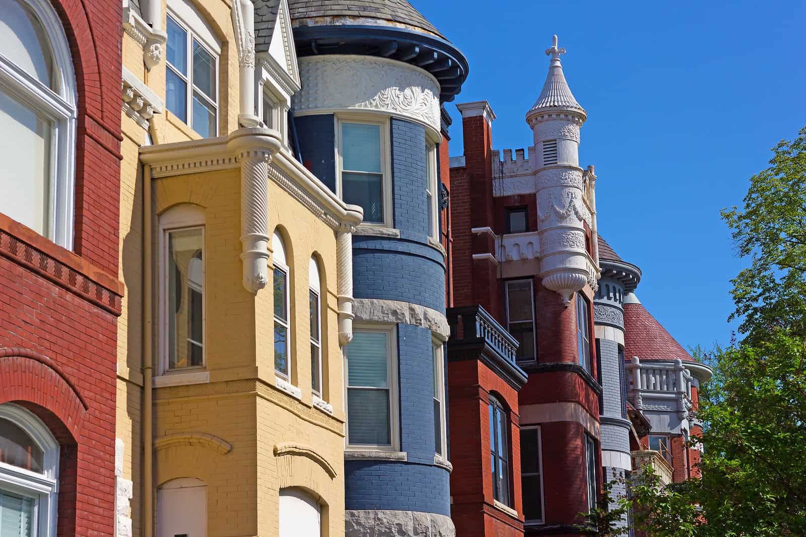Detailed view of colorful historic masonry and ornate architectural details of a Victorian-style bui.