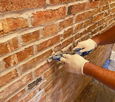 Restoring historic brickwork with tuckpointing techniques.
