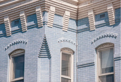 Historic masonry and tuckpointing on a Renaissance-style building facade.
