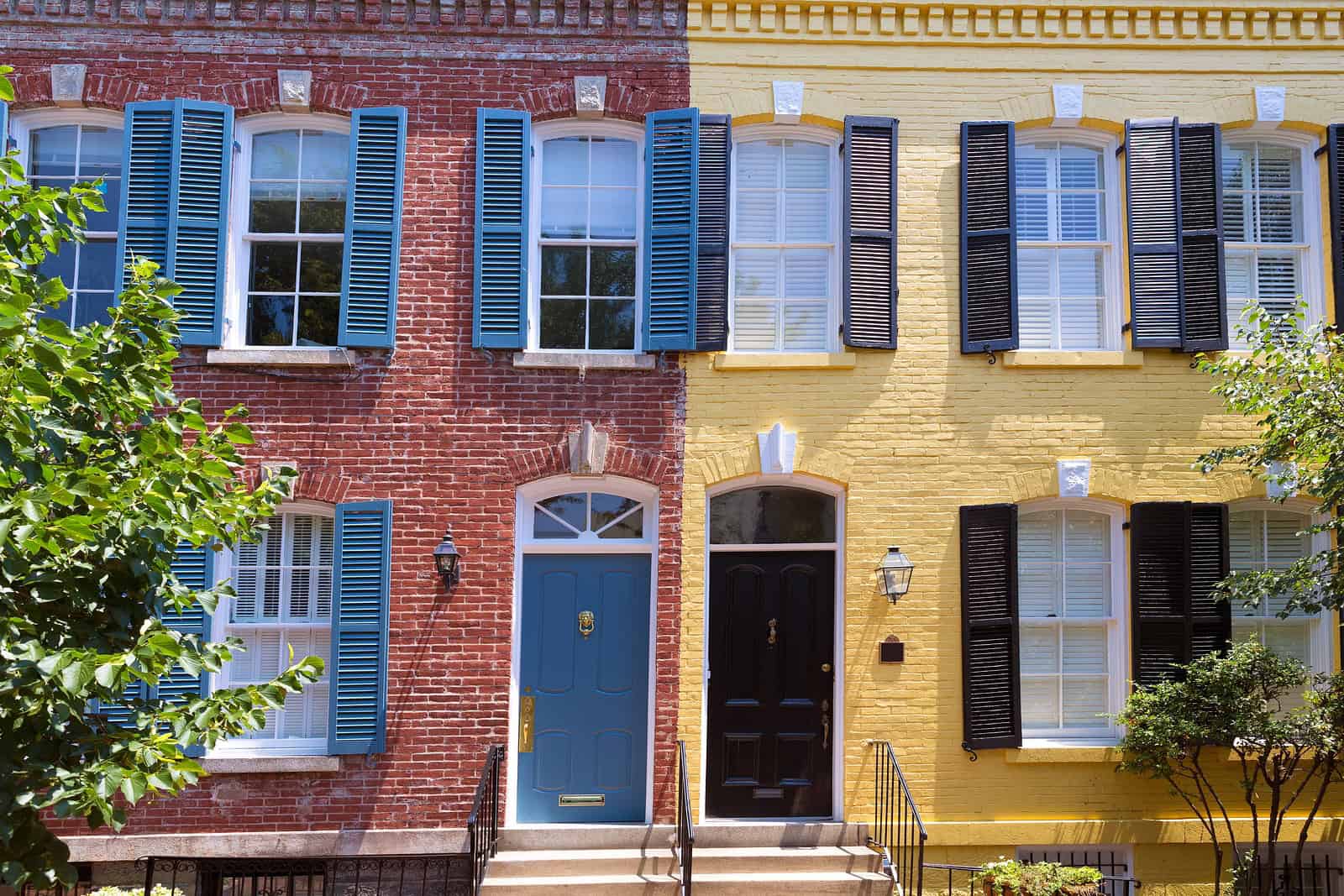 Beautiful historic brick townhouses with colorful facades and classic architectural details.