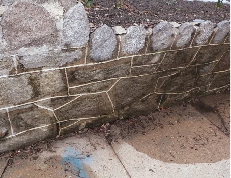 Close-up of historic masonry and tuckpointing on a stone wall.