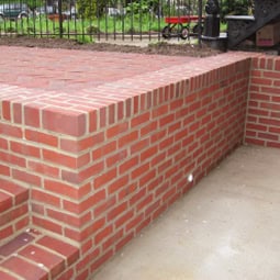 Brick wall with detailed masonry work and tuckpointing.