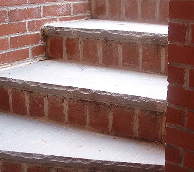 Close-up of brick staircase with detailed masonry and tuckpointing work.