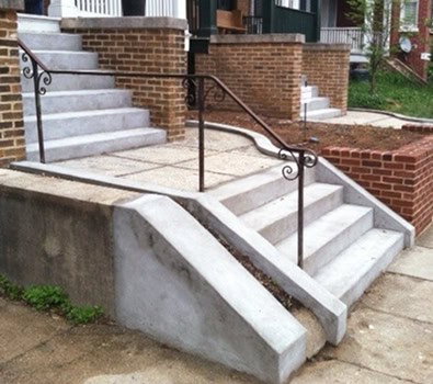 Restoration of historic masonry and tuckpointing on a brick building with concrete stairs and decora.