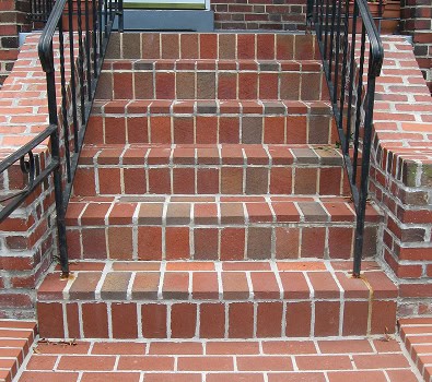 Restoration of historic brick stairs with precise tuckpointing and masonry work, enhancing durabilit.