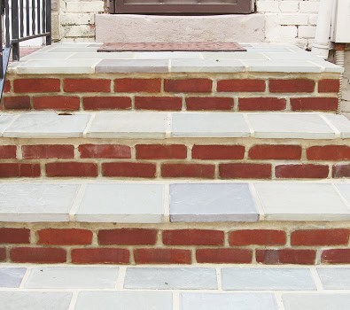 Restoration of historic brick and stone masonry with tuckpointing techniques.