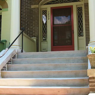 Historic masonry and tuckpointing work on a classic residential building entrance.