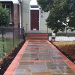 Historic masonry and tuckpointing work on a residential building's entrance pathway.