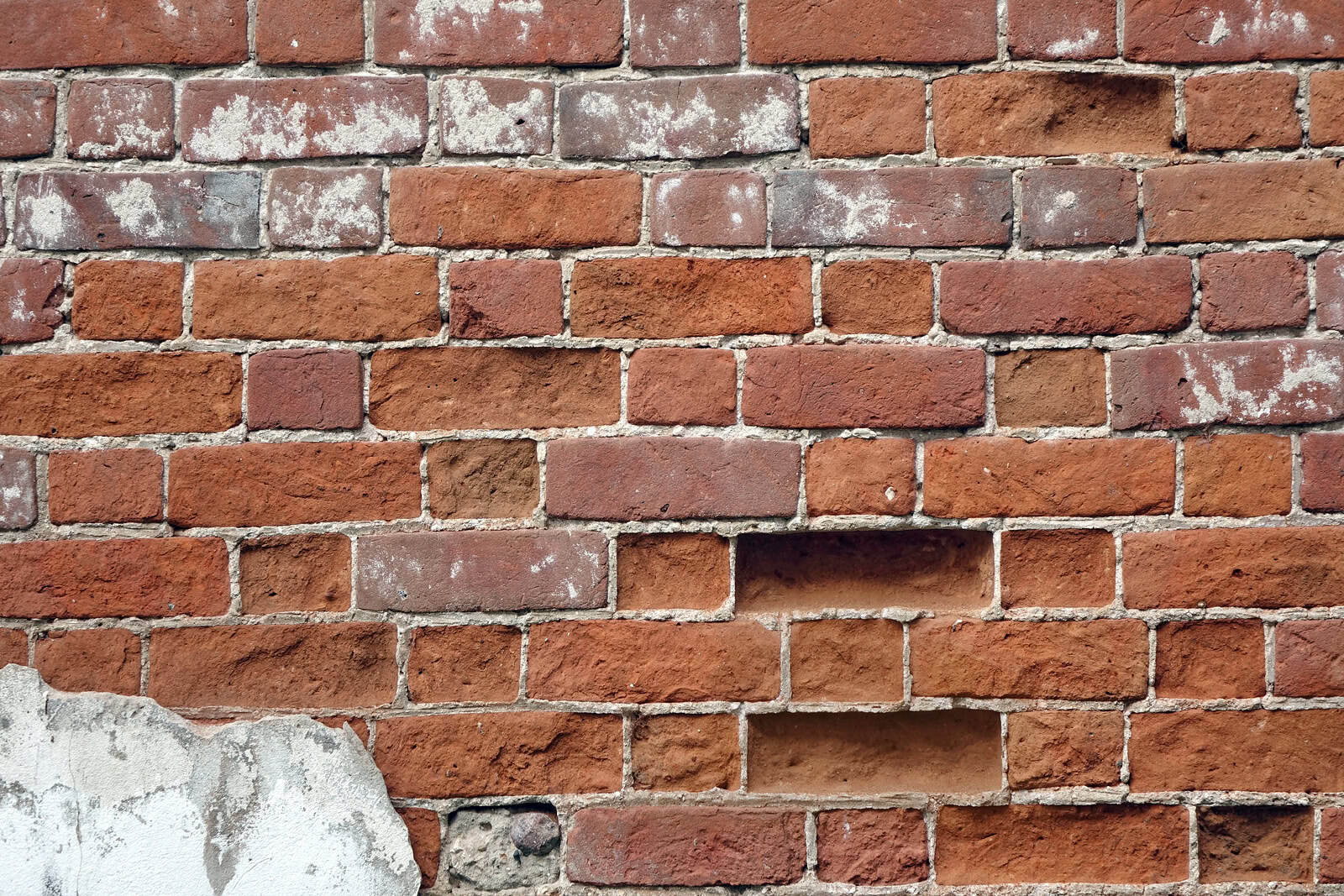 Close-up of historic brick masonry with tuckpointing and weathered mortar joints.