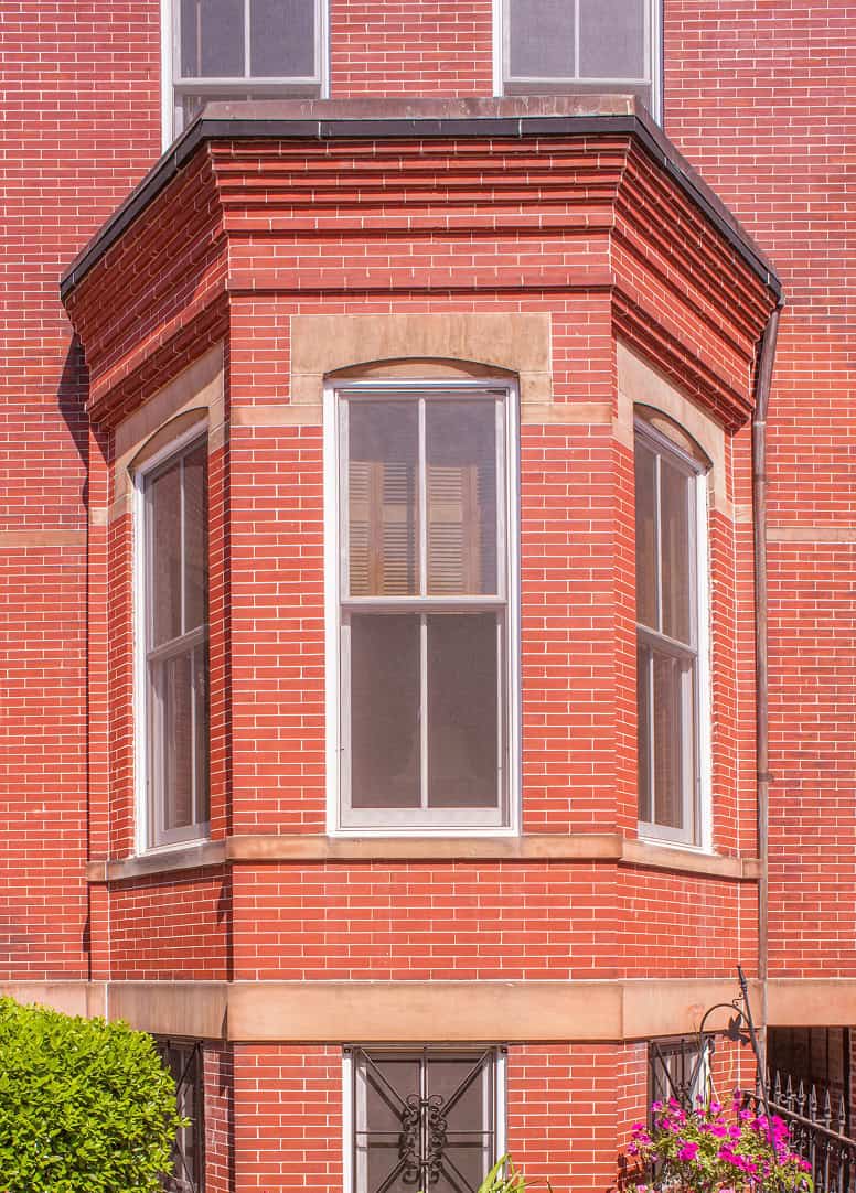 Close-up of historic brick masonry with detailed tuckpointing on a Victorian building.