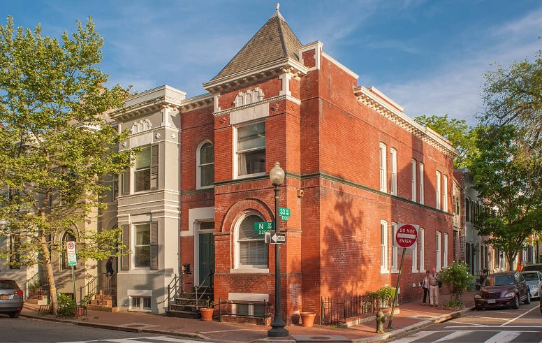 Historic brick building with detailed masonry and tuckpointing work in an urban setting.