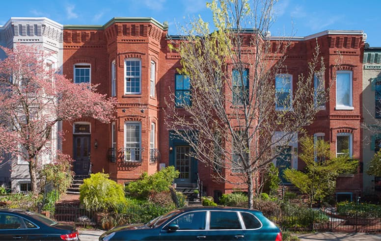 Historic brick townhouse with detailed masonry work and well-maintained facade.