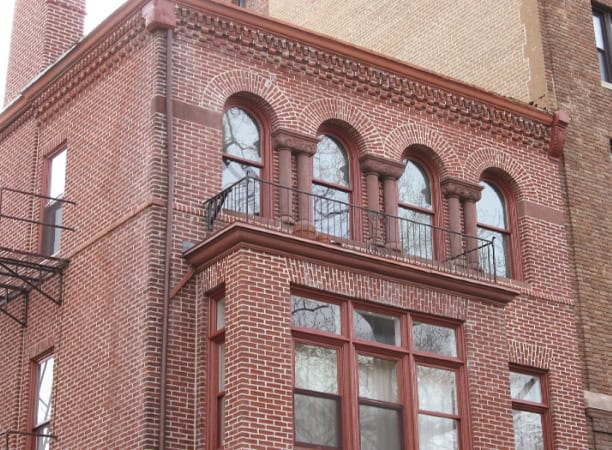 Historic brick building with detailed masonry and arched windows, showcasing Renaissance architectur.